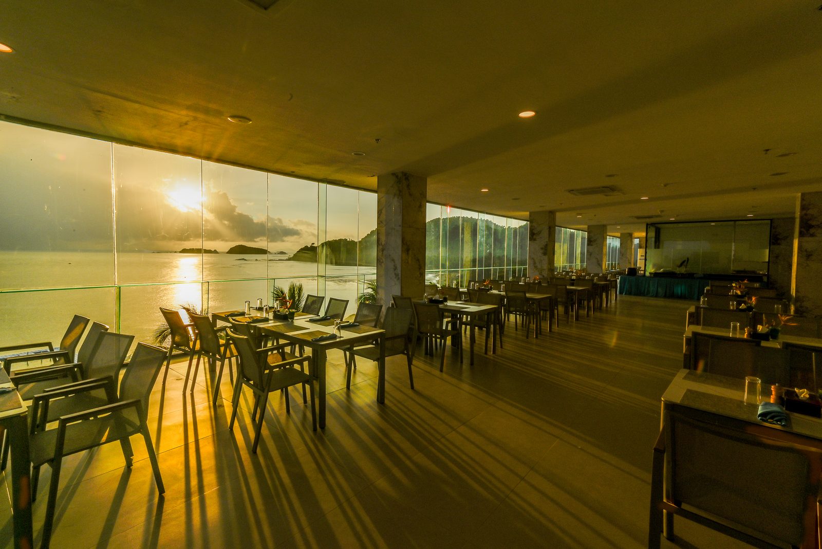 Glass-walled dining room at sunrise