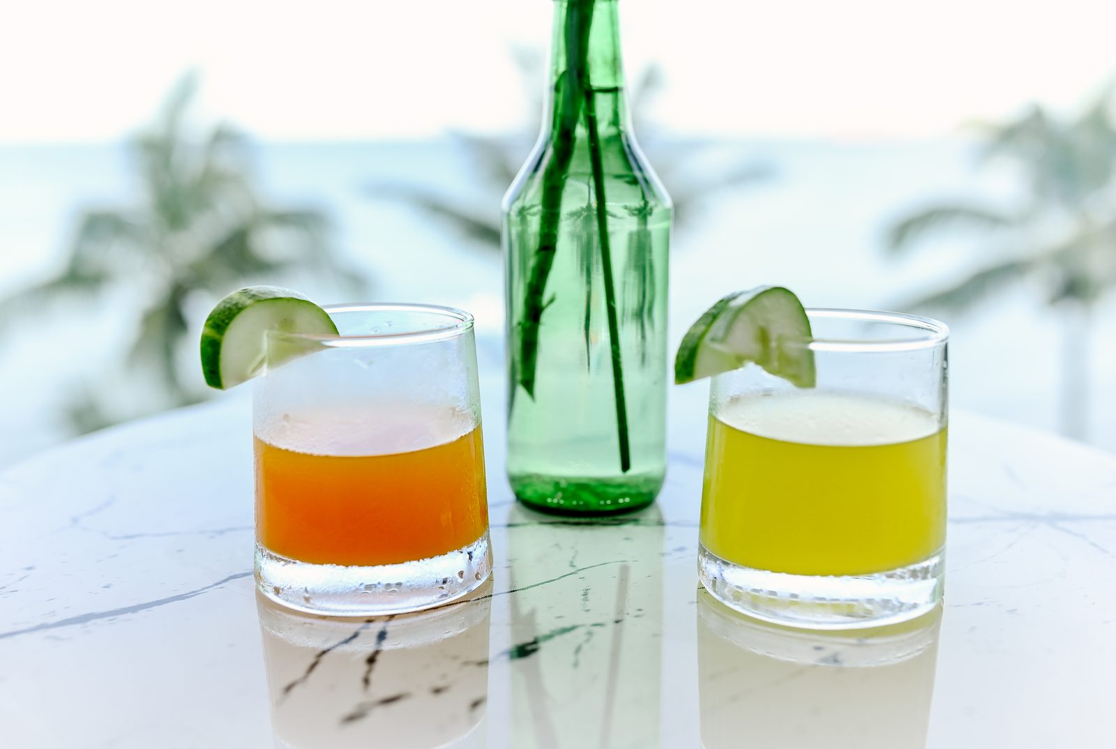 Welcome drinks on a marble table with palms behind